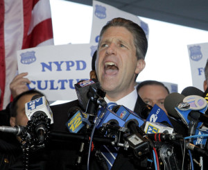 File- In this file photo of Oct. 28, 2011, Patrick Lynch, head of the nations largest police union, speaks at a news conference in support of the police officers indicted in a ticket-fixing scandal at the Bronx Supreme Court in New York. Theatrics arent a new tactic for Lynch, but an ongoing war of words with Mayor Bill de Blasio is a notch up even for Lynch, who is usually the most outspoken, the most amped up in the room. The 51-year-old has lead the Patrolmens Benevolent Association since 1999 and is up for re-election next year. (AP Photo/David Karp, File)