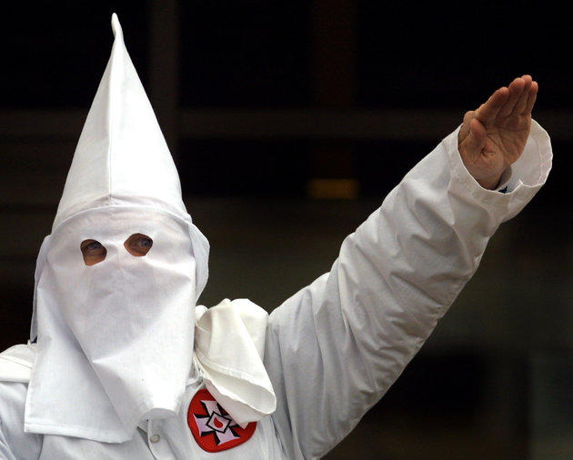 383374 02: A Klansman raises his left arm during a "white power" chant at a Ku Klux Klan rally December 16, 2000 in Skokie, IL. A Wisconsin chapter of the Ku Klux Klan held a "White Pride Rally" on the steps of the Cook County Courthouse located in Skokie, a suburb northwest of Chicago. (Photo by Tim Boyle/Newsmakers)